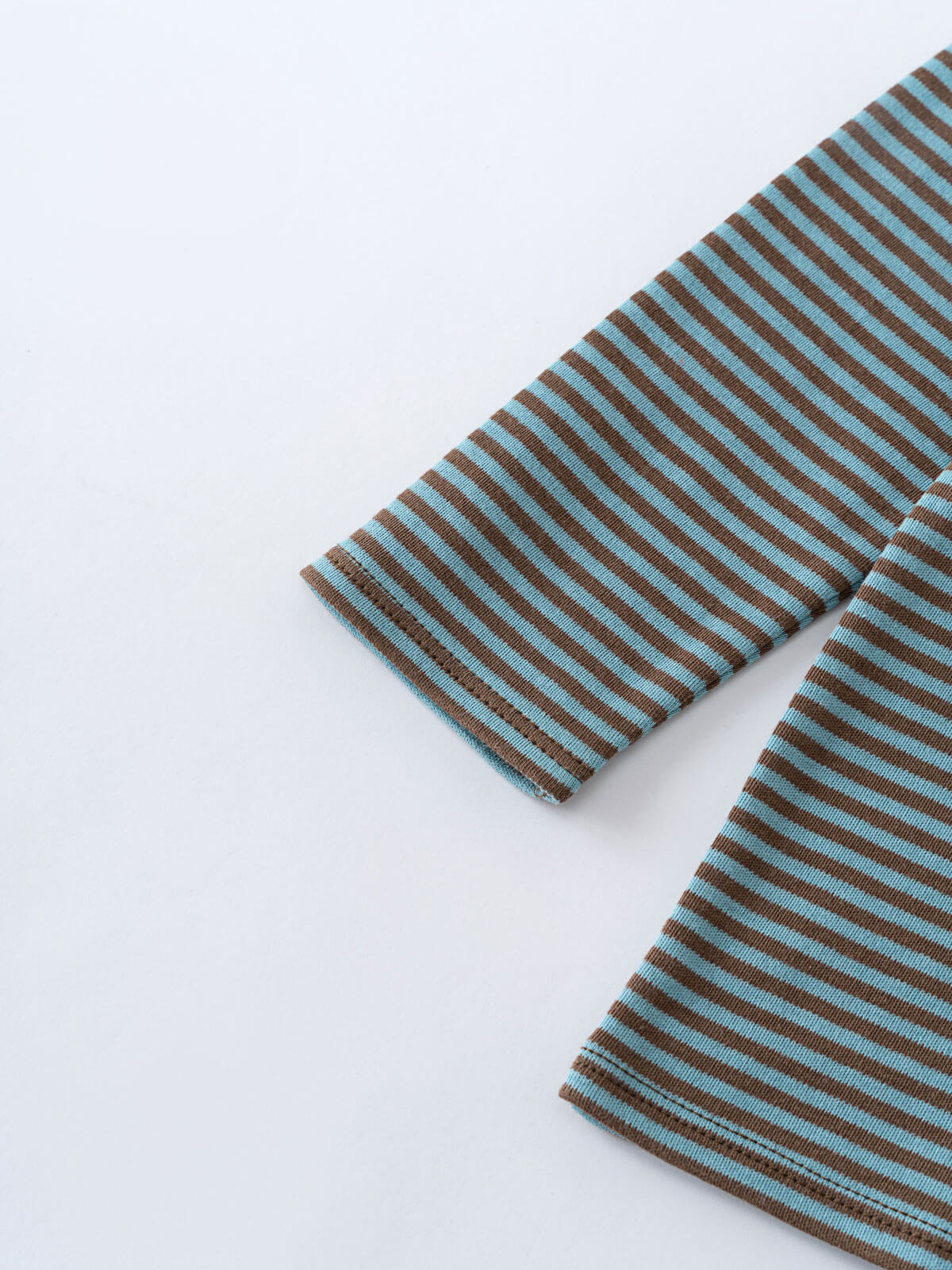 Close-up of striped fabric sleeve and hem in blue and brown Henley Long Sleeve Tee - Lake Boys