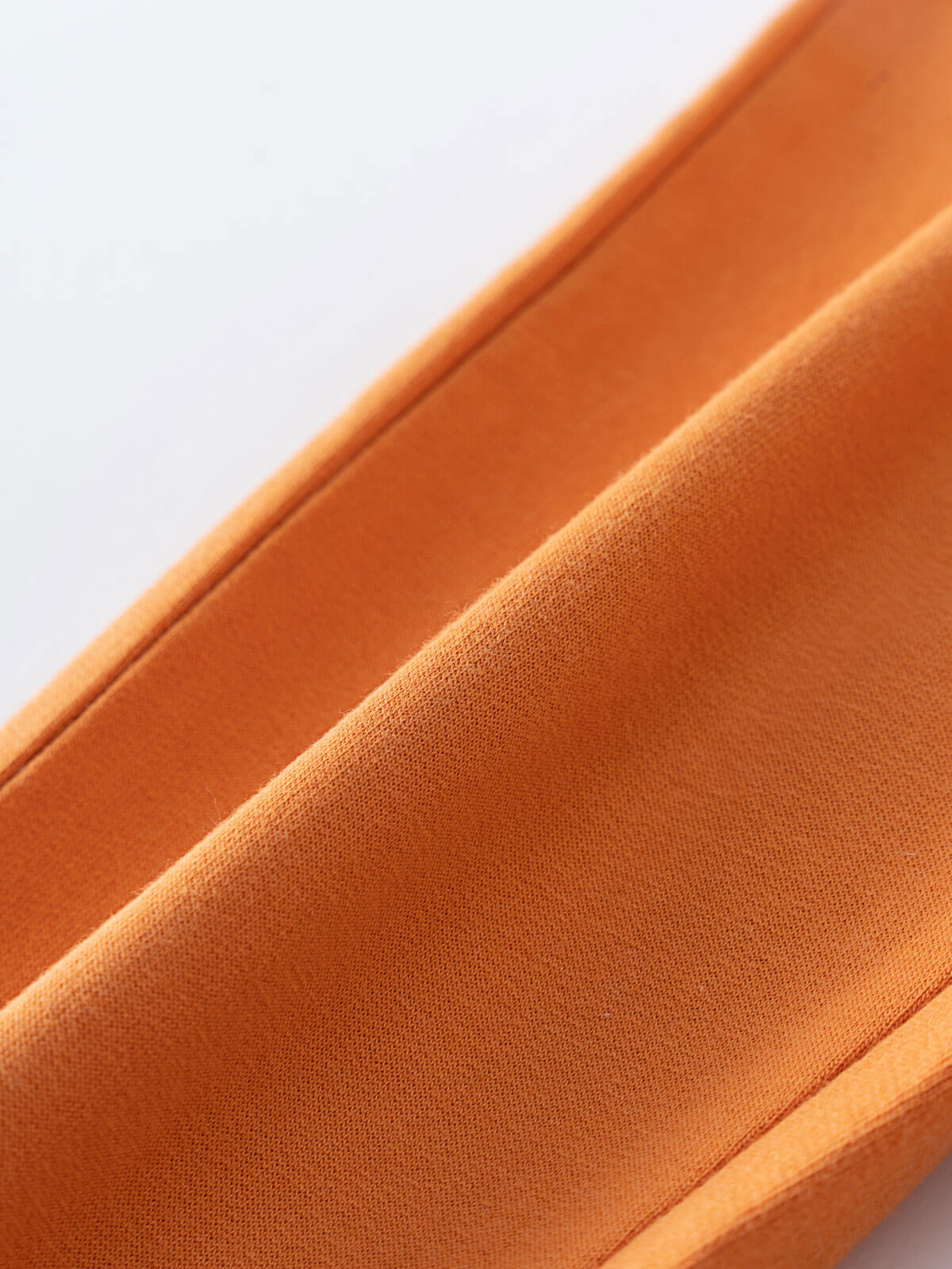 Close-up of orange fabric showing texture and stitching detail Sweatpants - Pumpkin Boys