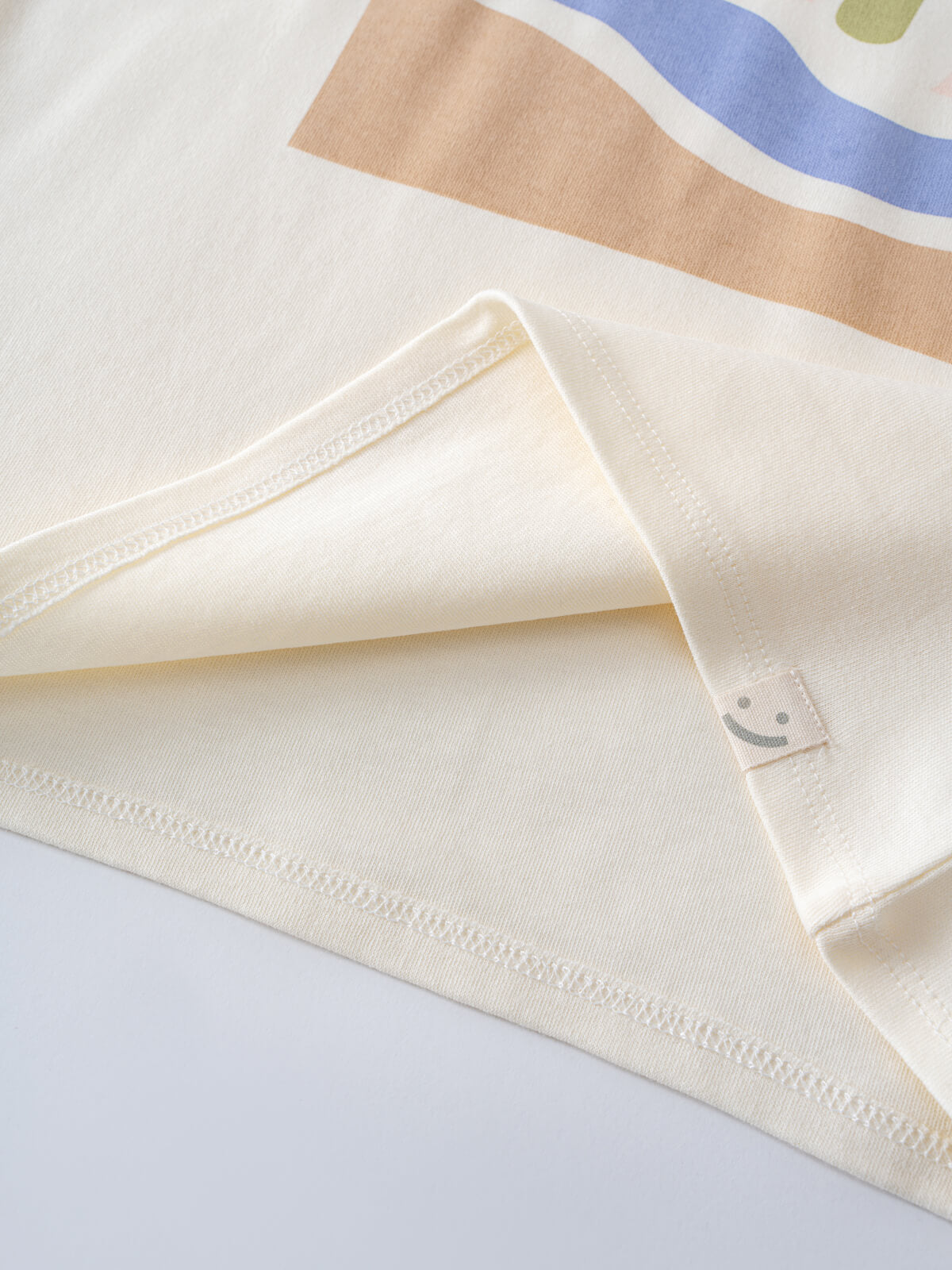Close-up of cream-colored t-shirt with visible stitching and fabric tag Axel Short Sleeve Tee - Palm Beach Boys
