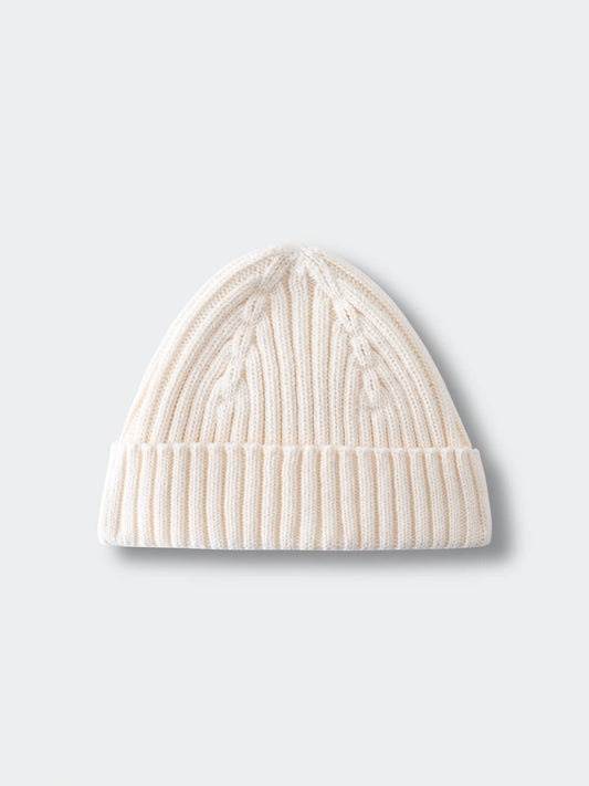 White knit beanie on a light gray background