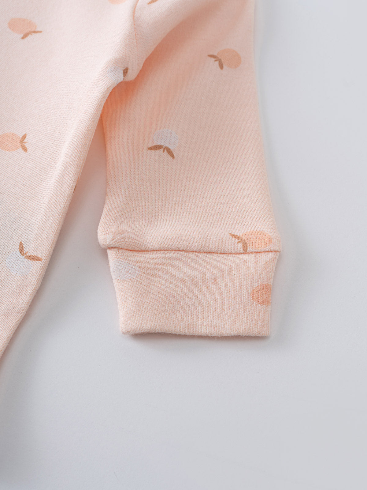 Close-up of a pale pink sleeve with apple print pattern and ribbed cuff Ella Long Sleeve Bodysuit - Apples Baby girl