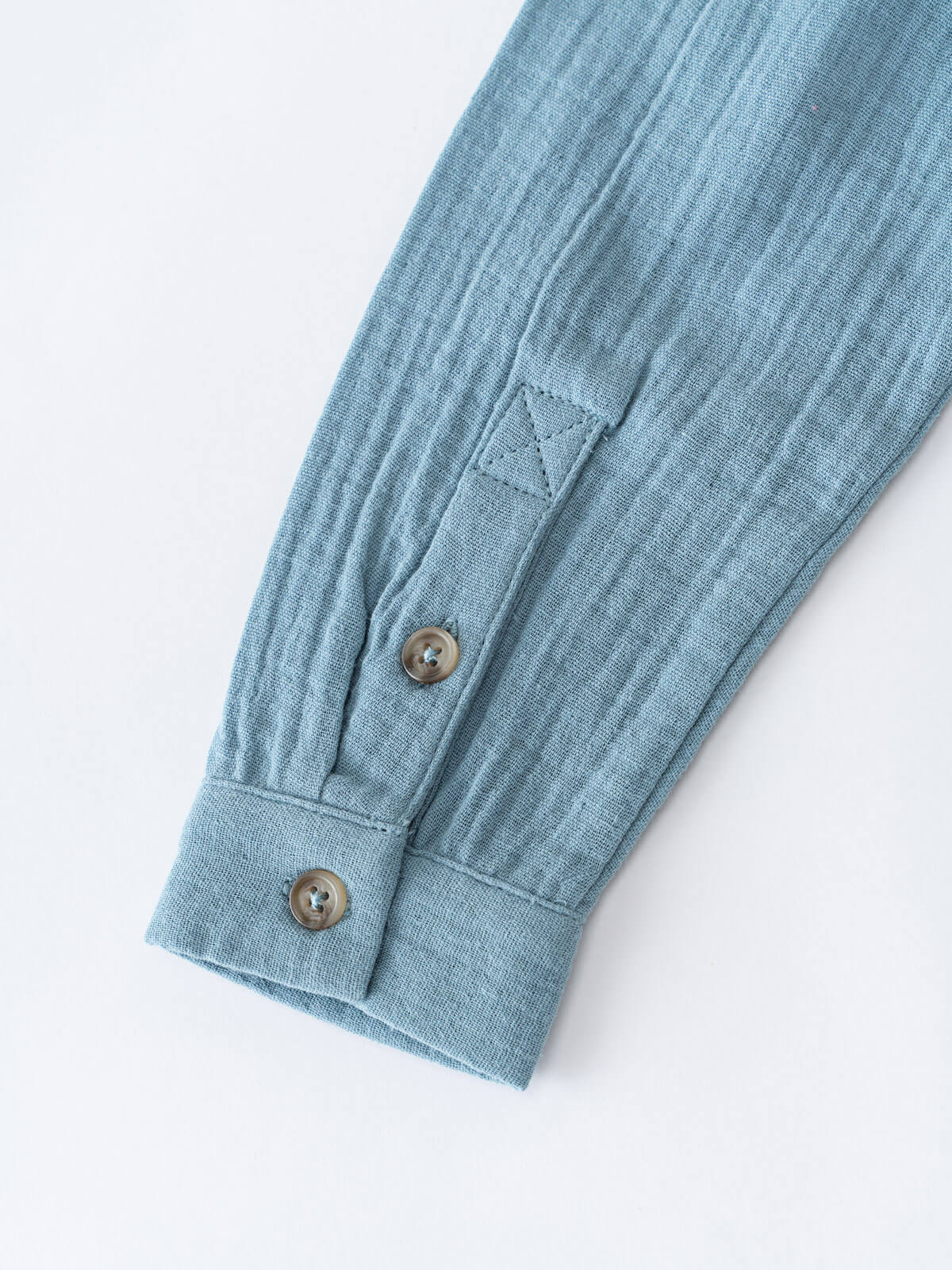 Close-up of a light blue shirt with button details on a white background Grandad Shirt - Lake Blue Boys