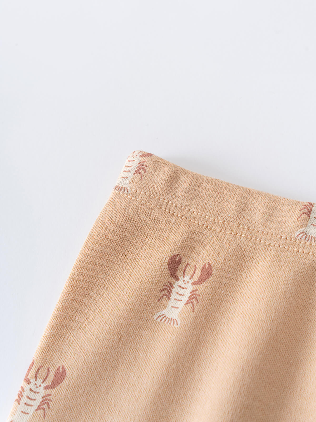 Close-up of peach fabric with small lobster print pattern Heath Leggings - Charlie's Crew Baby boy