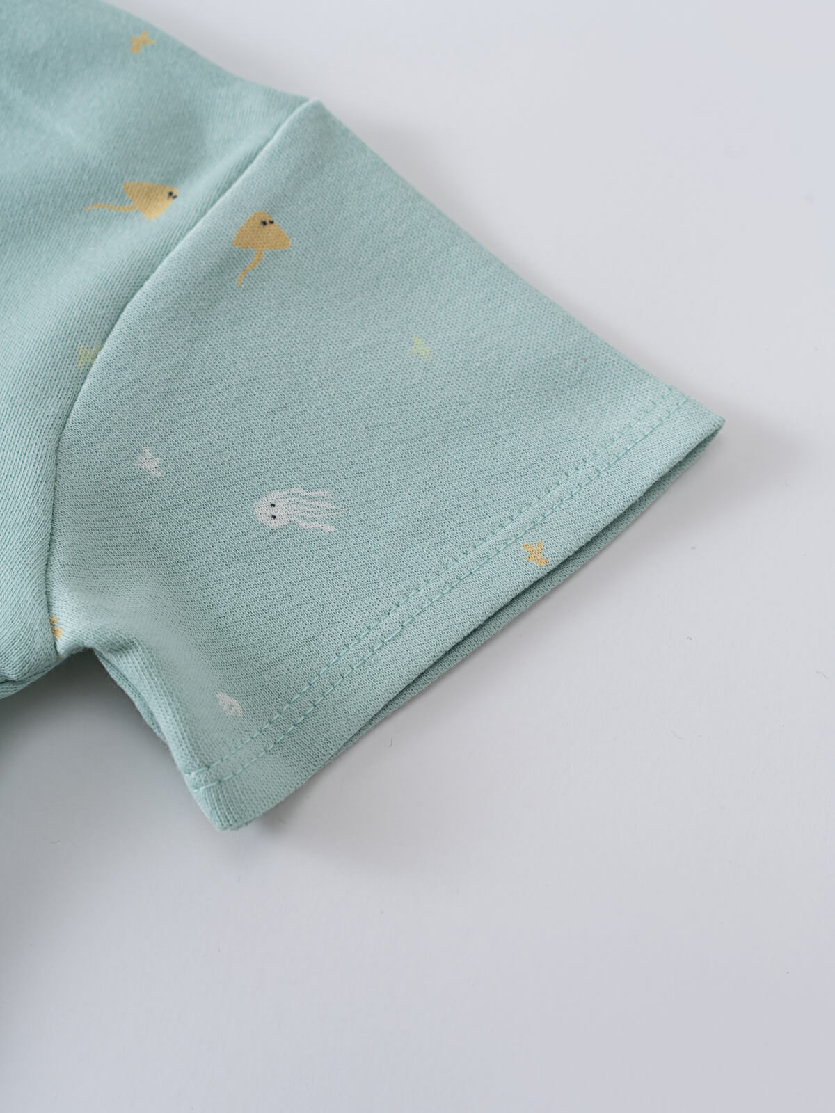 Close-up of light blue fabric sleeve with small printed sea creature pattern Jacob Short Sleeve Tee - Sea Friends Baby boy