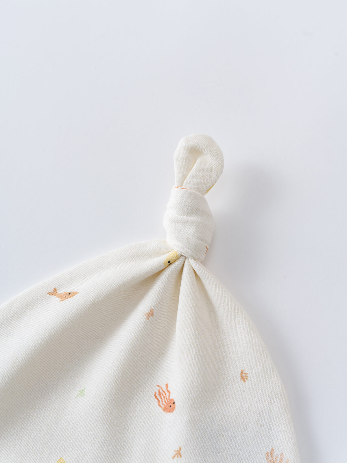White fabric baby hat tied in a knot with small ocean animal prints Kennedy Knot Hat - Ocean Buddies Baby girl