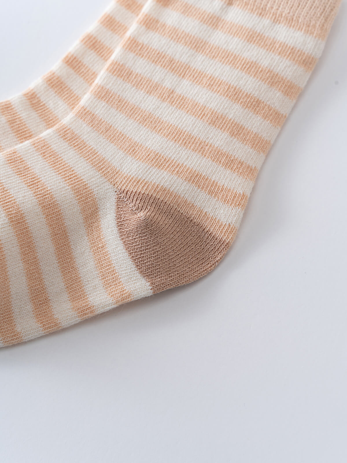 Close-up of a striped sock heel in peach and cream colors Kids Socks 3 pack - Pink Shell Girls