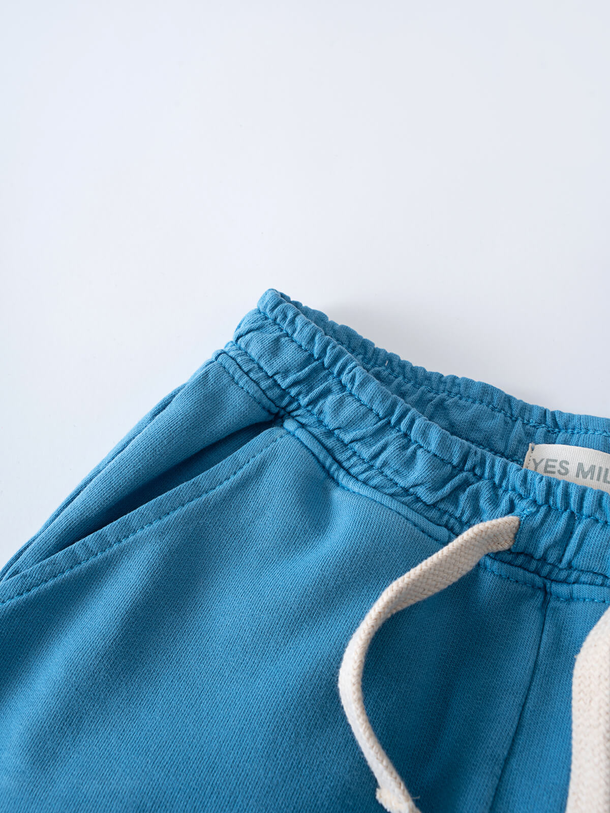 Close-up of blue sweatpants with elastic waistband and white trim detail Light Sweatpants - Marine Boys