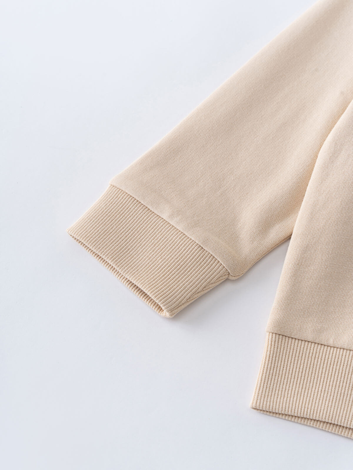 Close-up of beige sweatshirt sleeves showing ribbed cuffs and fabric texture Feature Print Sweatshirt - Hiking Bear Baby boy