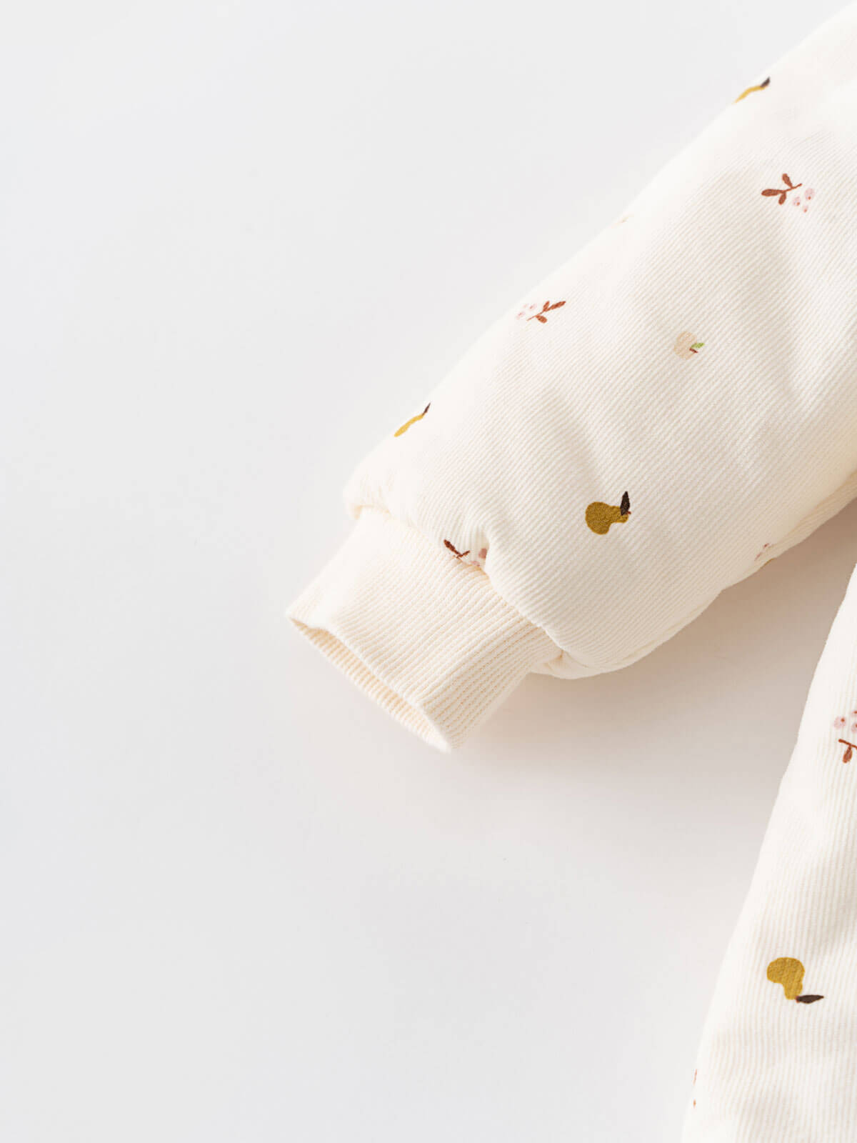 Cream hooded baby pram suit with fruit pattern on a light gray Printed Pram Suit - Autumn Harvest Ecru Baby girl