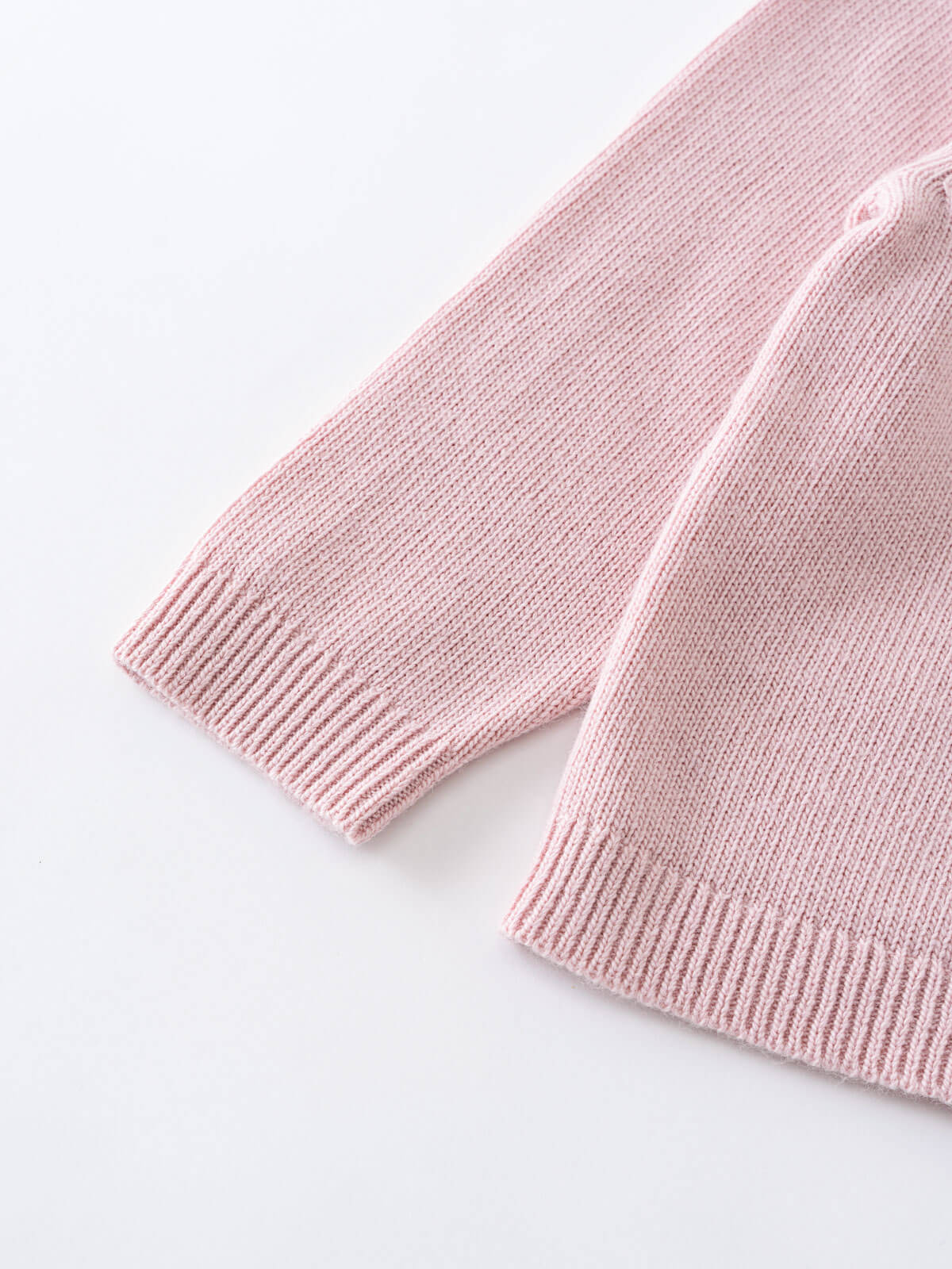 Close-up of pink knitted cardigan sleeve with ribbed cuff detail Ruffle Cardigan - Blush Girls