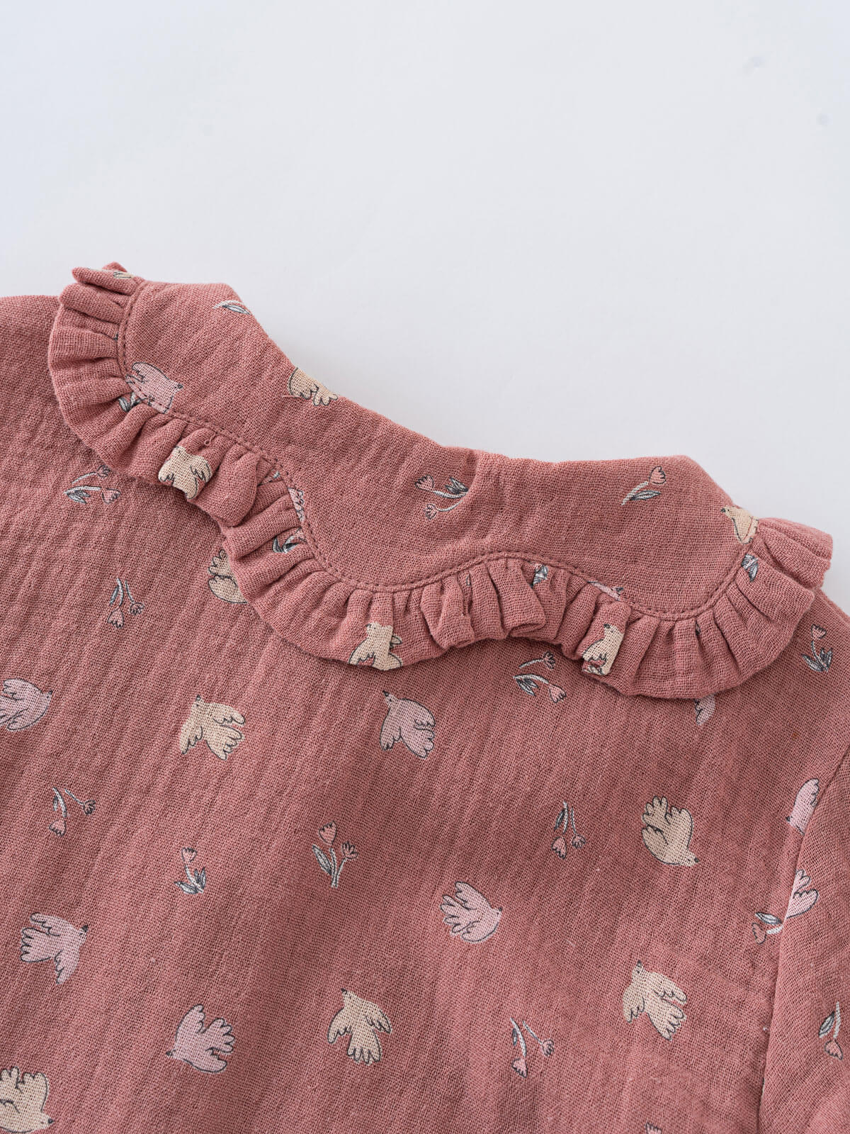 Pink children's blouse with ruffled collar and floral pattern on a white background Ruffle Woven Blouse - Bird And Blossom Rosehip Girls