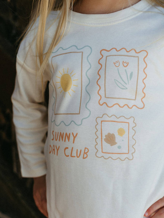 Children's long-sleeve shirt with 'Sunny Day Club' design featuring sun, flowers, and text.