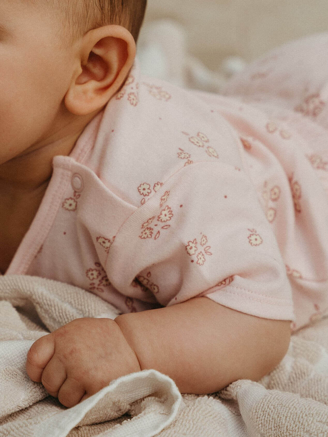 Baby in a soft cotton printed bodysuit, a light baby Christmas outfit for a NZ summer Christmas Day