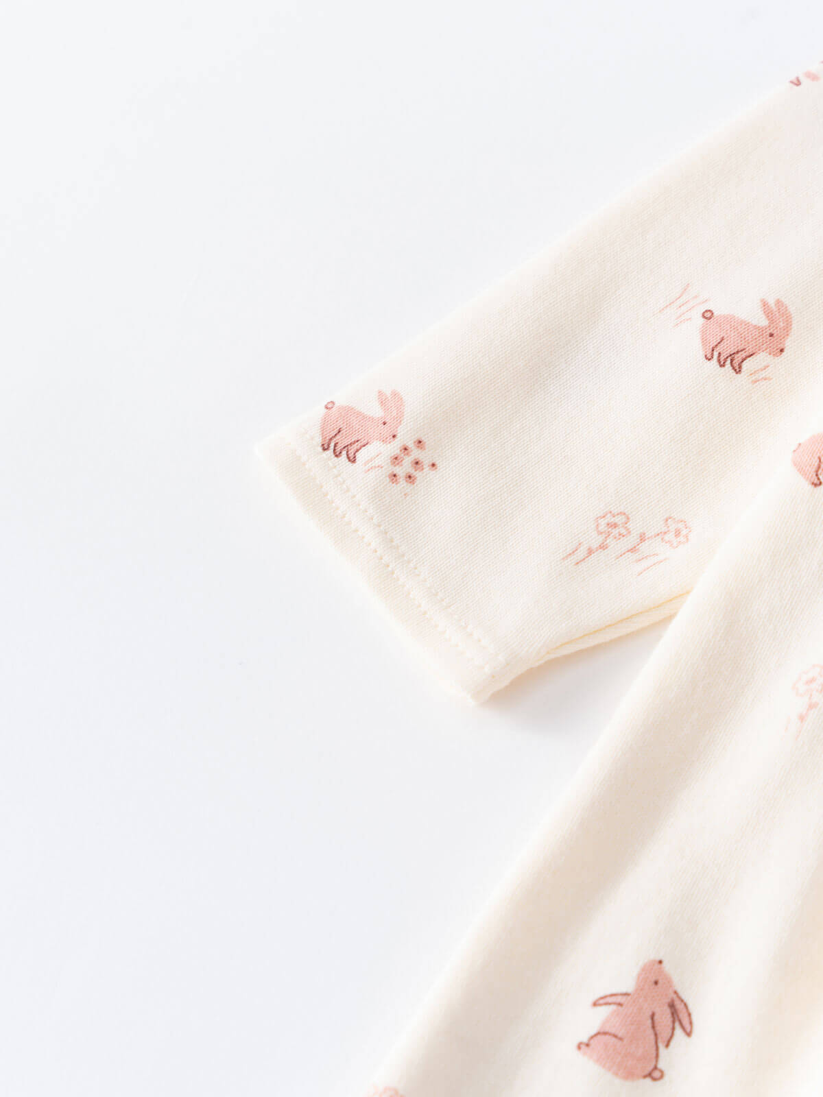 Close-up of cream-colored fabric with pink animal embroidery pattern Baby Long Sleeve Jersey Dress - Meadow Friends Ecru Baby girl