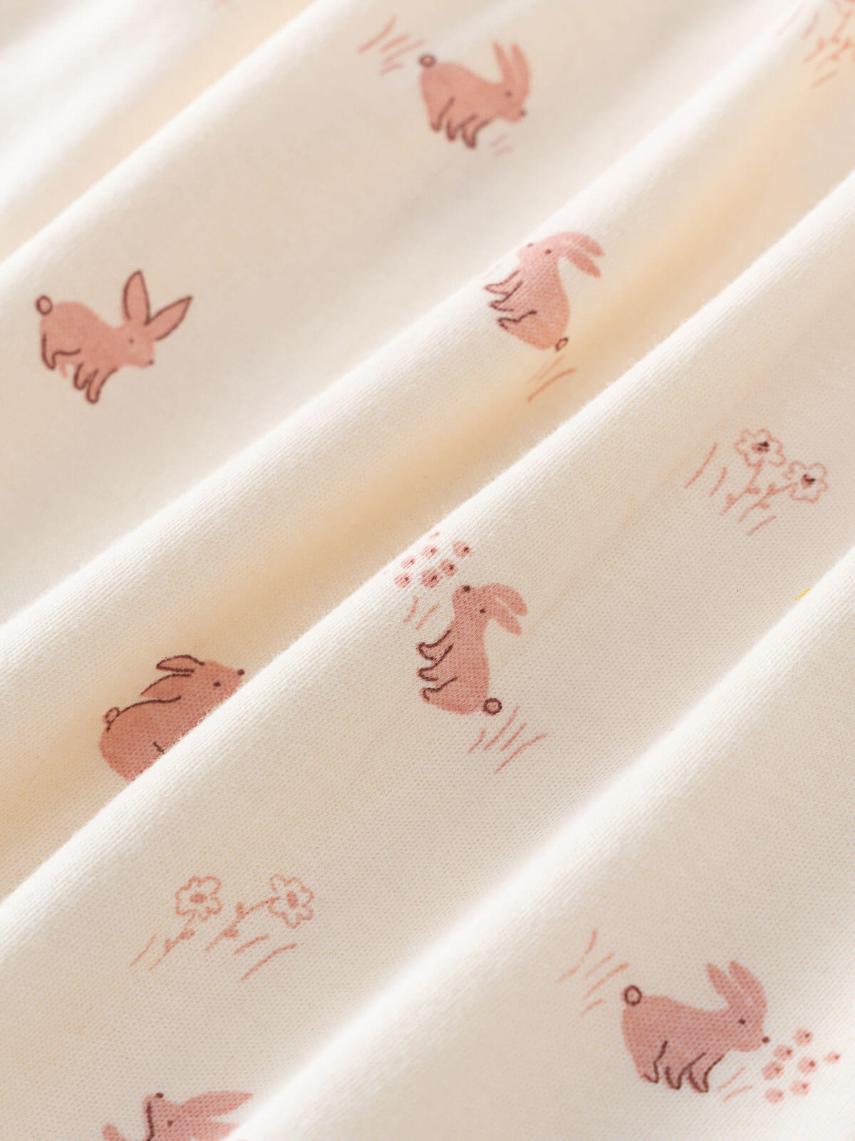 Close-up of cream fabric with pink printed rabbits and flowers pattern Baby Long Sleeve Jersey Dress - Meadow Friends Ecru Baby girl