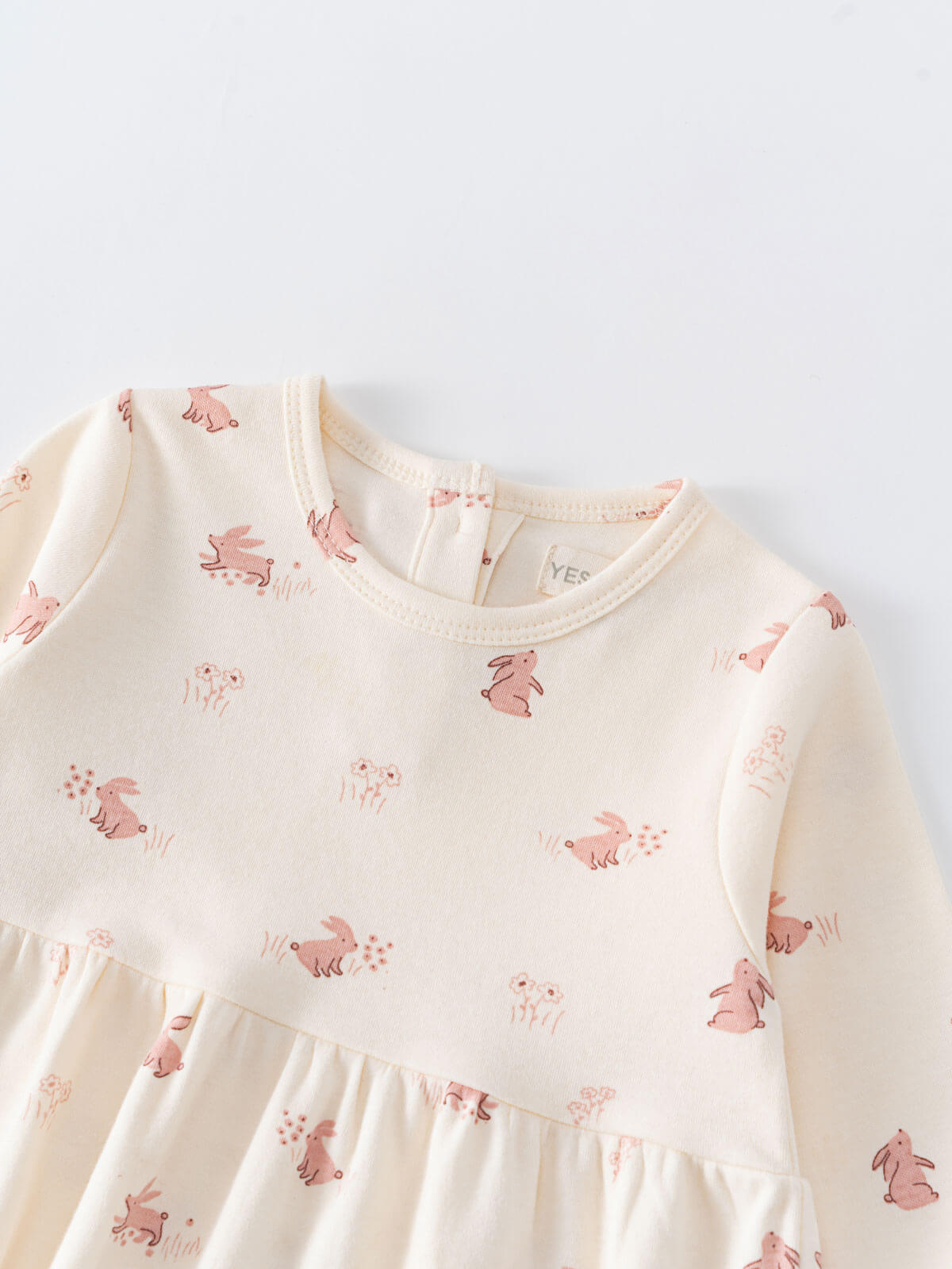Close-up of cream baby dress with pink rabbit print pattern Baby Long Sleeve Jersey Dress - Meadow Friends Ecru Baby girl