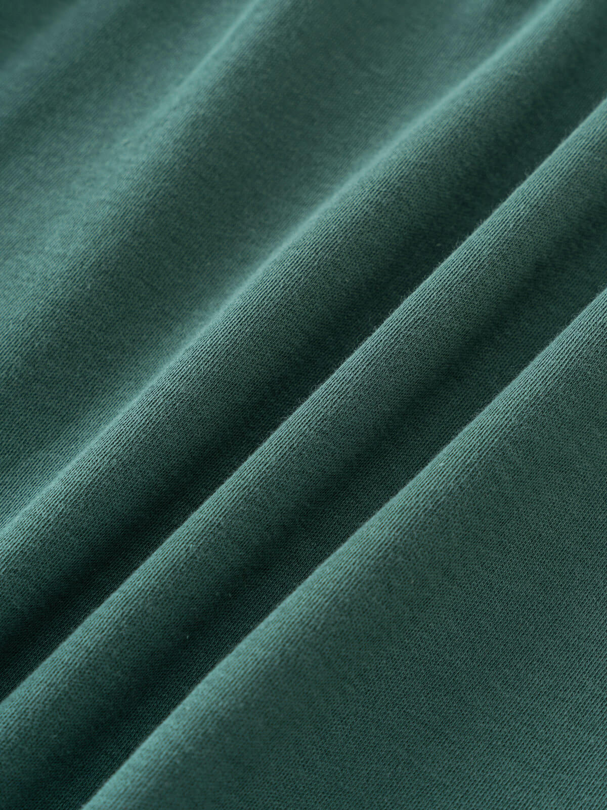 Close-up of teal green fabric with soft folds and visible texture Baby Long Sleeve Jersey Dress - Meadow Friends Baby girl