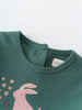 Close-up of green jersey fabric with pink rabbit and flower print Baby Long Sleeve Jersey Dress - Meadow Friends Baby girl