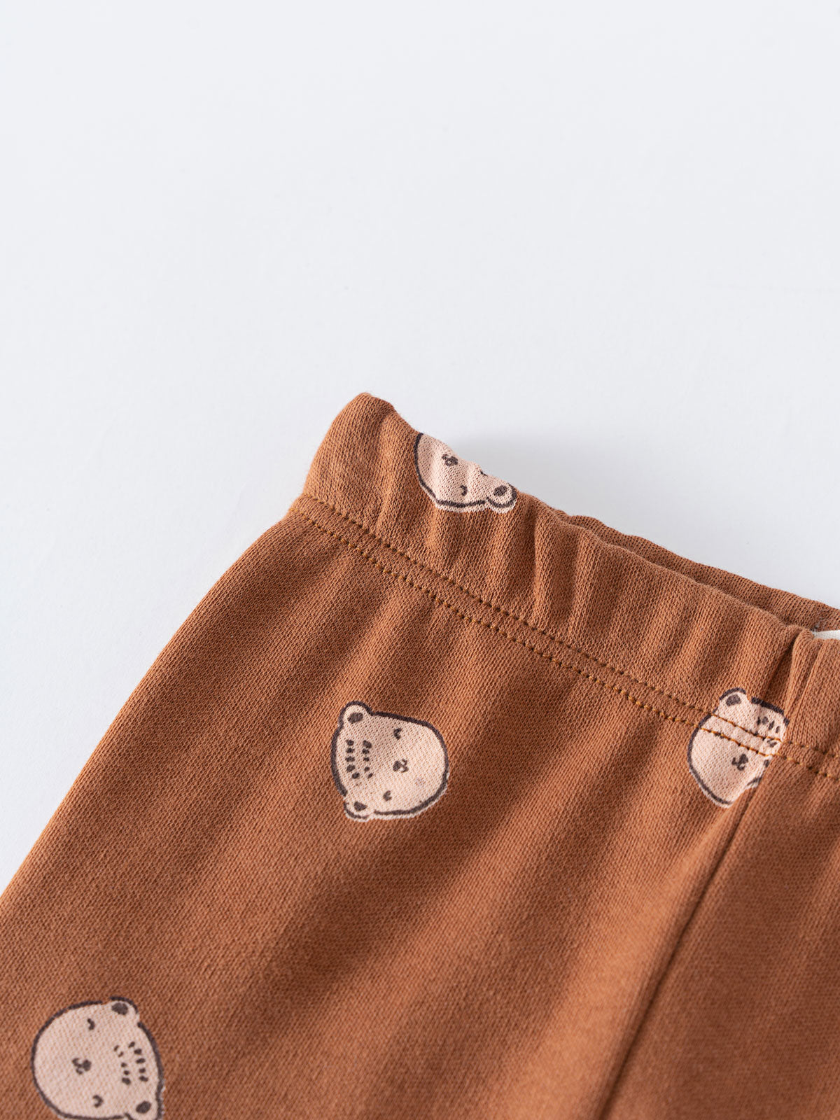 Close-up of rust-colored baby leggings with embroidered bear faces Baby Printed Leggings - Cosy Bear Russet Baby boy