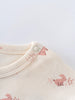 Close-up of cream fabric with pink animal print and snap button fastening Baby Printed Short Sleeve Tee - Meadow Friends Ecru Baby girl