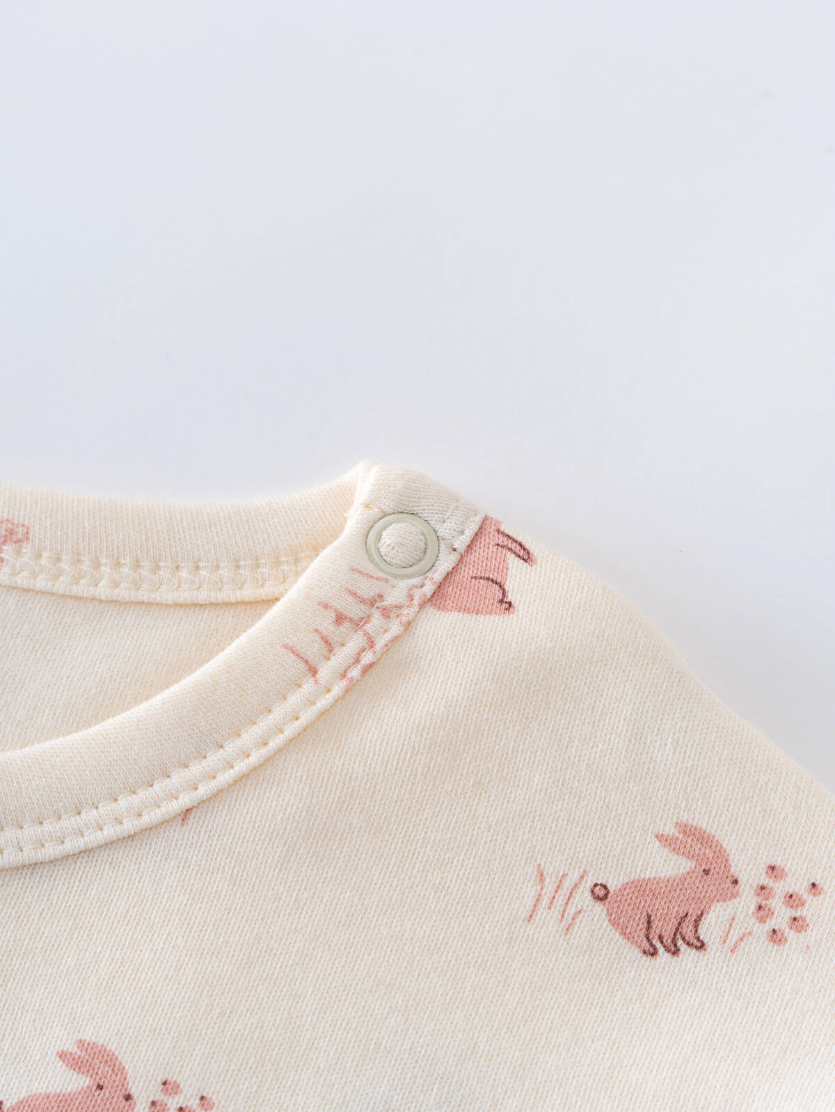 Close-up of cream fabric with pink animal print and snap button fastening Baby Printed Short Sleeve Tee - Meadow Friends Ecru Baby girl