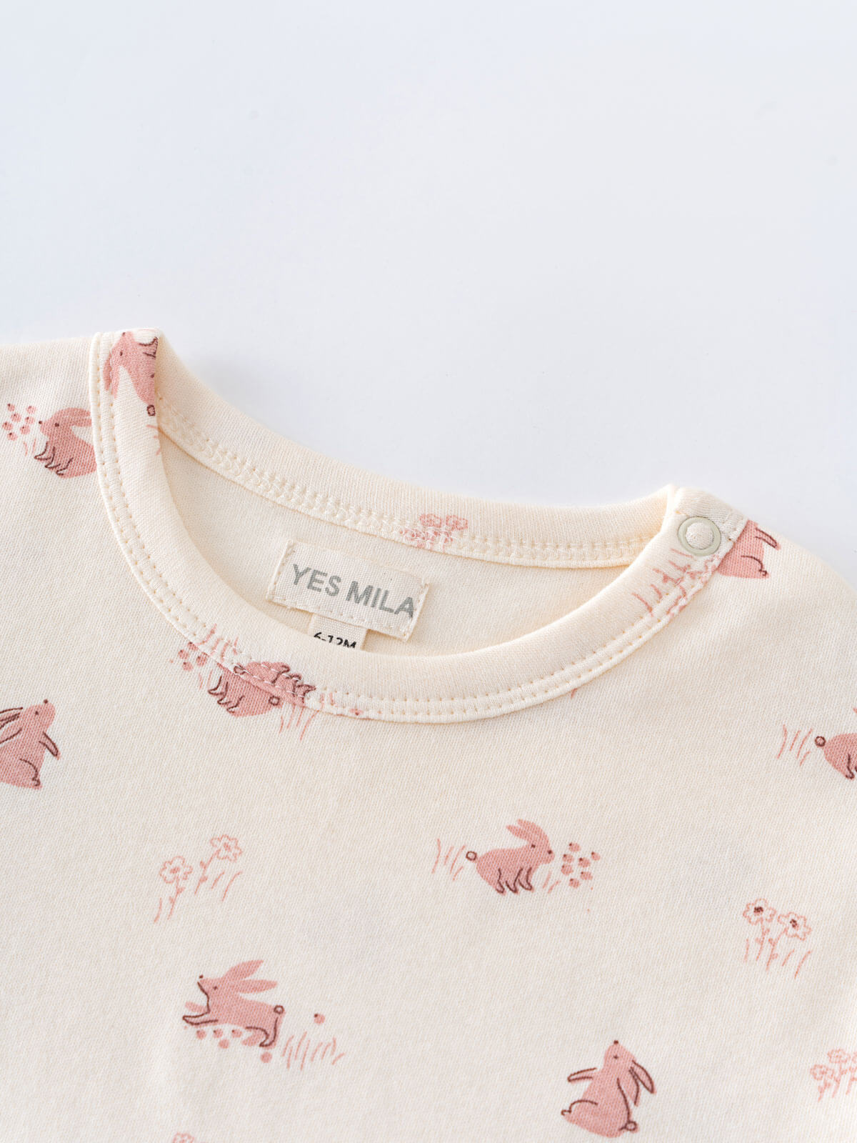 Close-up of cream-colored baby shirt collar with pink rabbit print pattern Baby Printed Short Sleeve Tee - Meadow Friends Ecru Baby girl
