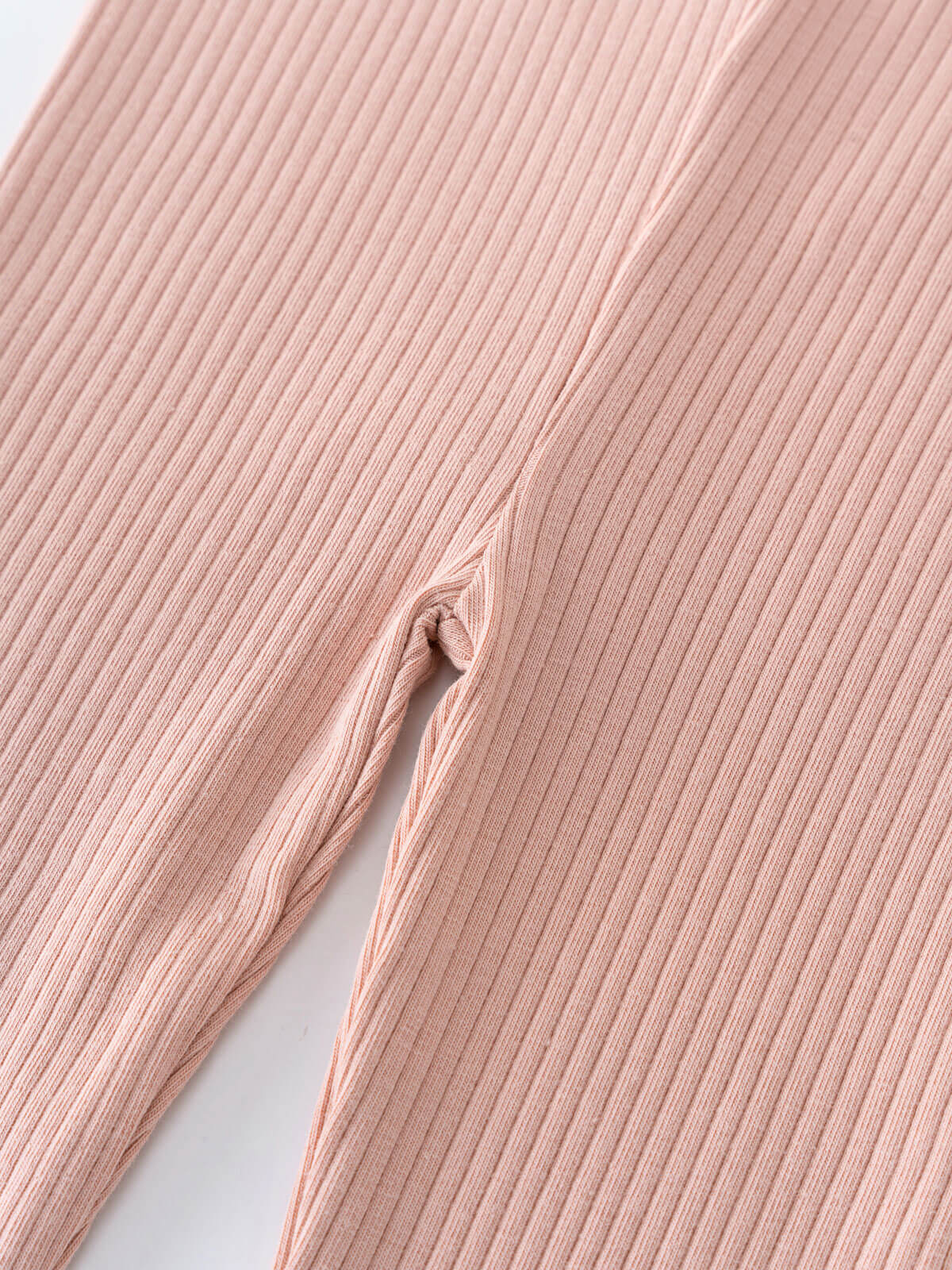 Close-up of ribbed blush pink fabric showing texture and seam detail Baby Ribbed Leggings - Blush Baby girl