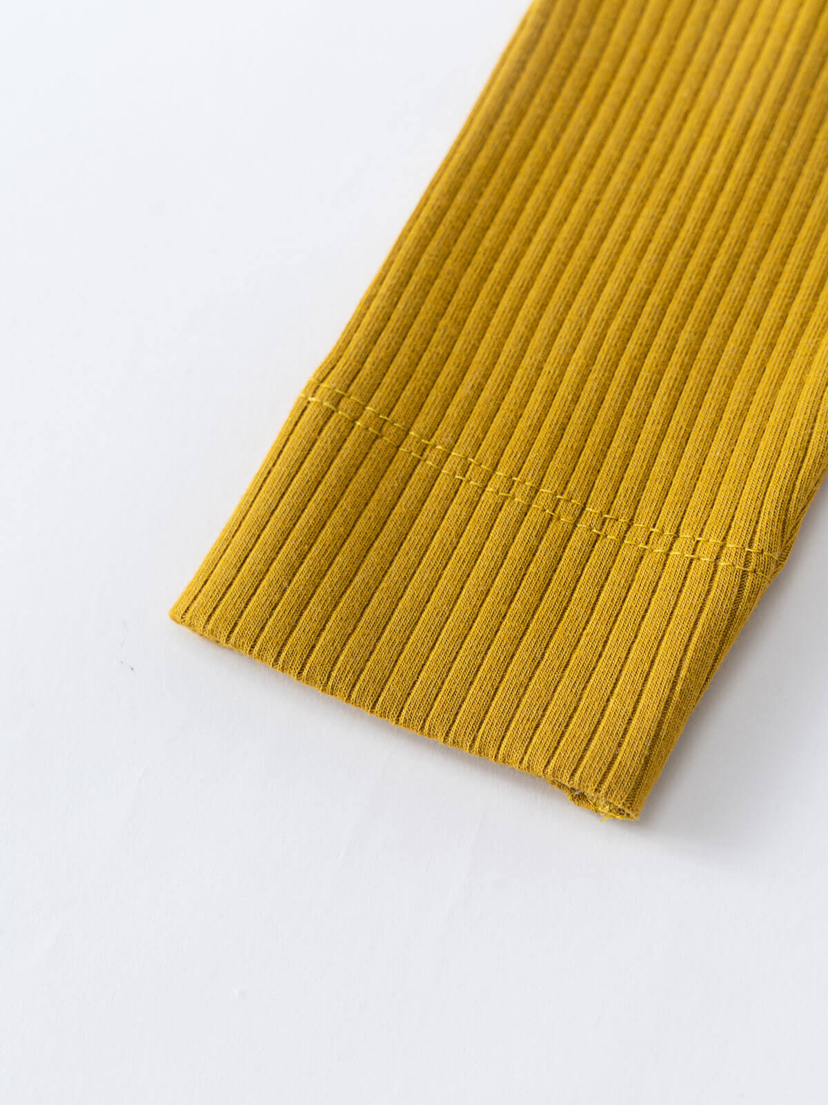 Close-up of mustard yellow ribbed fabric cuff on white background Baby Ribbed Leggings - Golden Pear Baby boy