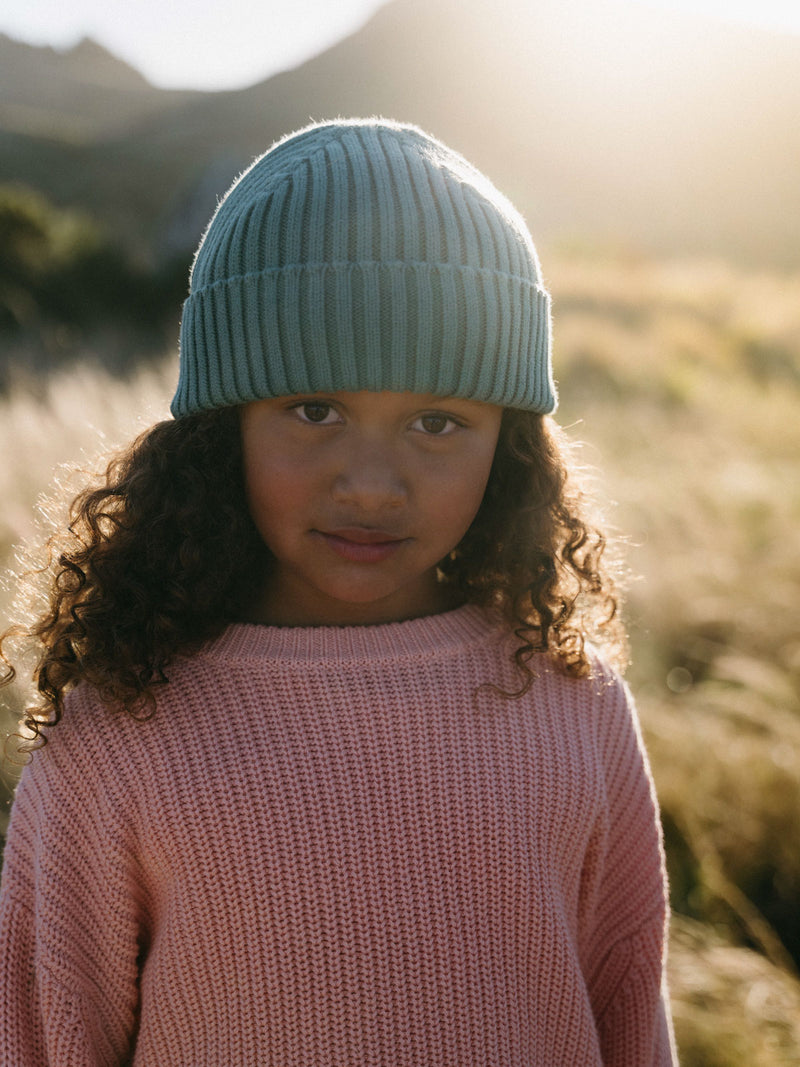 Young girl wearing a light blue beanie and pink knitted sweater outdoors Ribbed Jumper - Mallow Girls