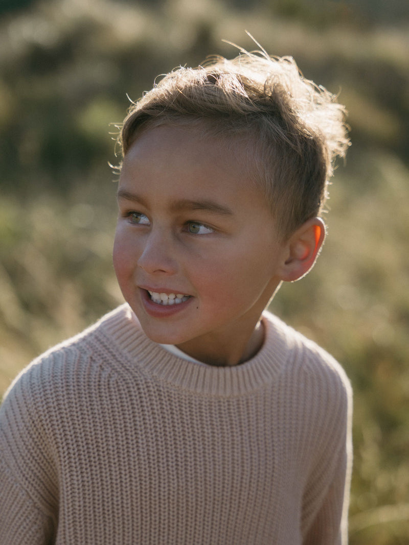Young boy wearing a beige ribbed sweater outdoors in natural light Ribbed Jumper - Clay Girls and Boys