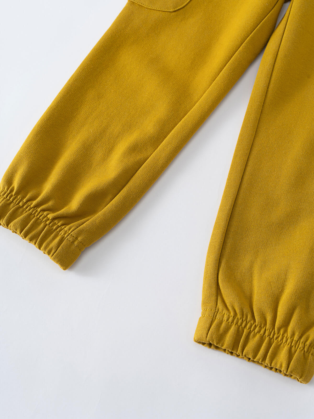 Close-up of mustard yellow sweatpants showing elastic cuffs and ribbed texture Cargo Sweatpants - Golden Pear Boys