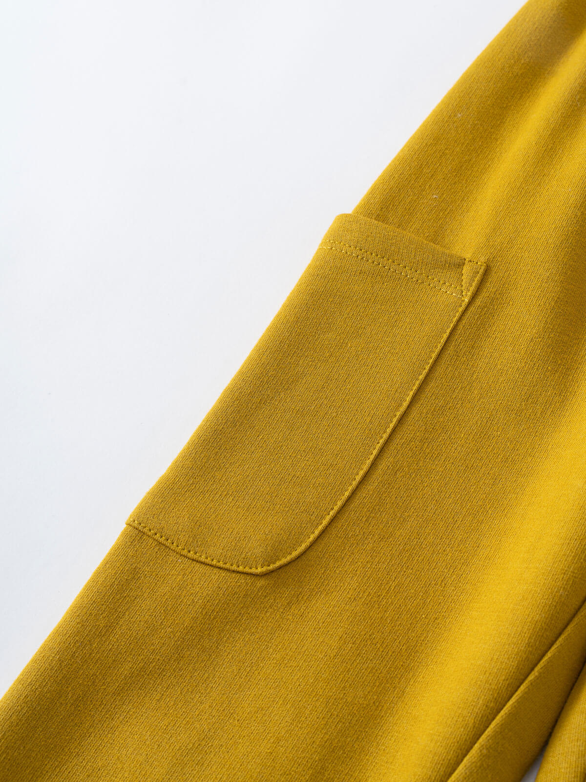 Close-up of a mustard yellow sweatpant pocket detail on fabric Cargo Sweatpants - Golden Pear Boys