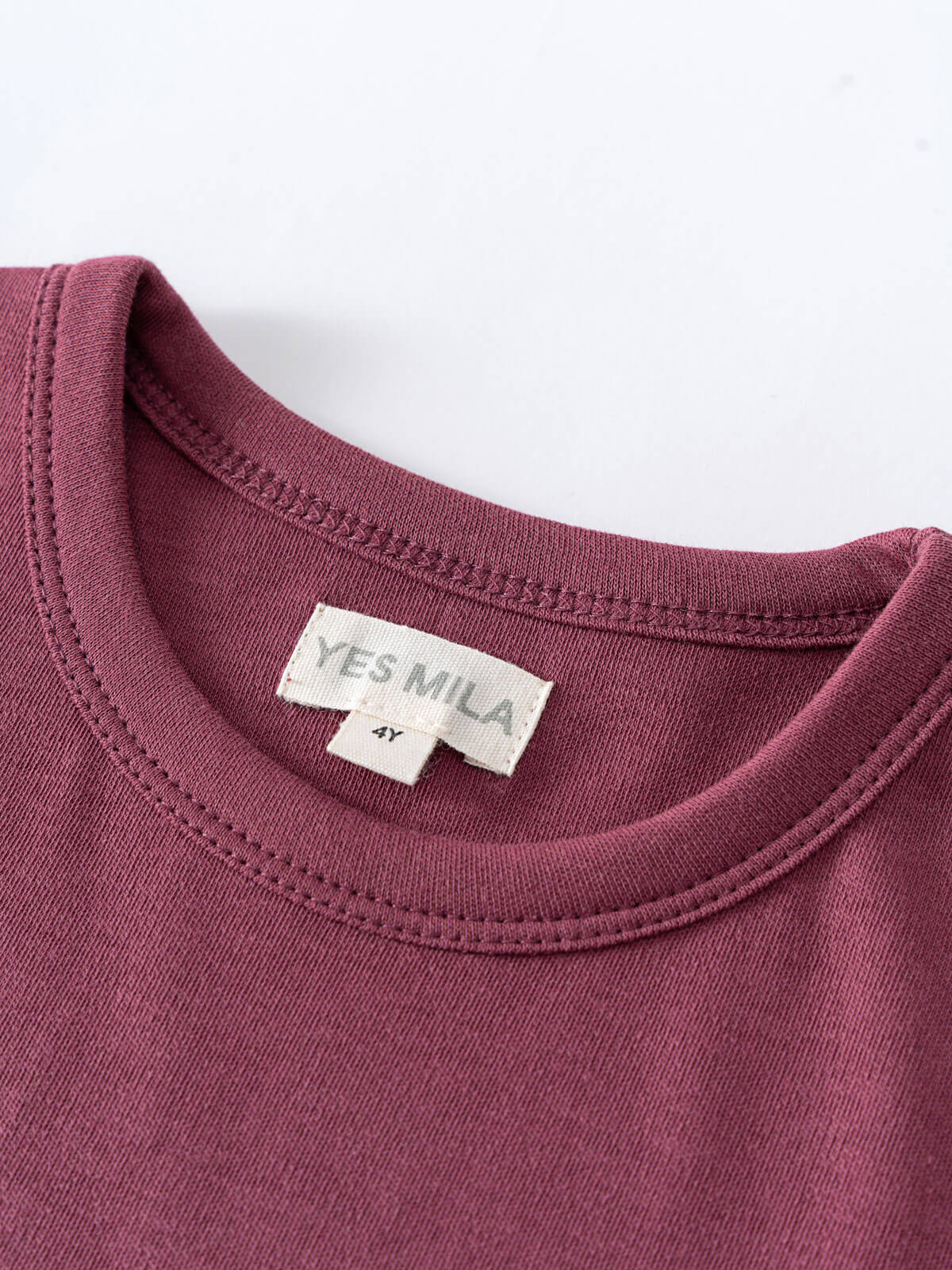 Close-up of a mauve t-shirt neckline with white label showing size 4Y Feature Print Short Sleeve Tee - Forest Gathering Girls