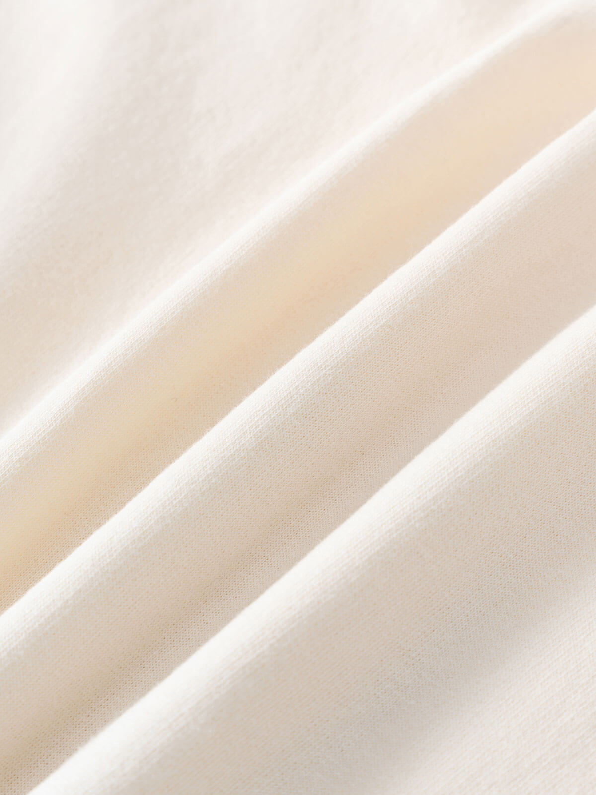 Close-up of cream-colored fabric with soft diagonal folds and visible texture Feature Print Sweatshirt - Bird And Blossom Girls