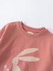 Close-up of a pink sweatshirt with a white rabbit print design Feature Print Sweatshirt - Forest Gathering Girls