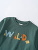 Close-up of a green sweatshirt with colorful "WILD" lettering and small animal graphics Feature Print Sweatshirt - Wild Baby boy