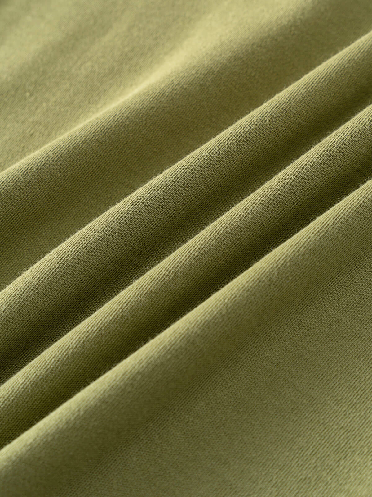 Close-up of olive green fabric with diagonal folds and texture Henley Short Sleeve Tee - Moss Boys
