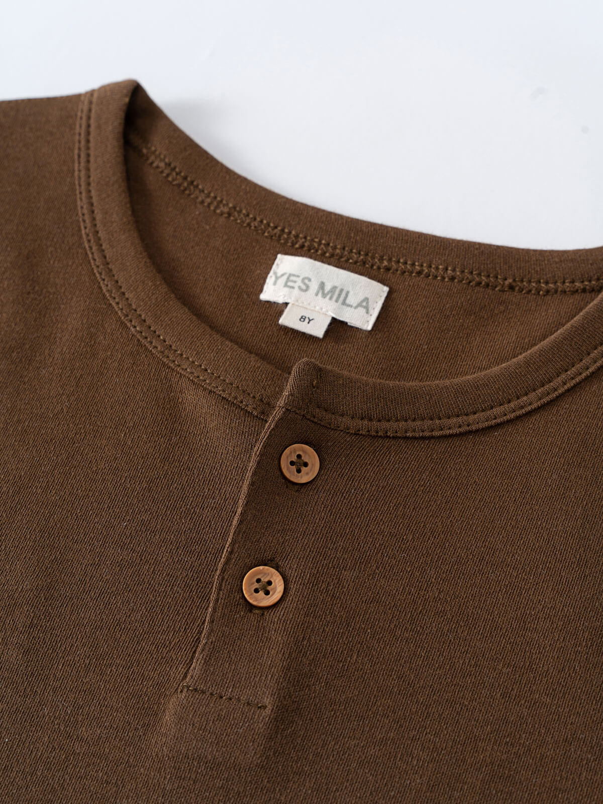 Close-up of a brown henley shirt neckline with two buttons Henley Short Sleeve Tee - Spruce Boys
