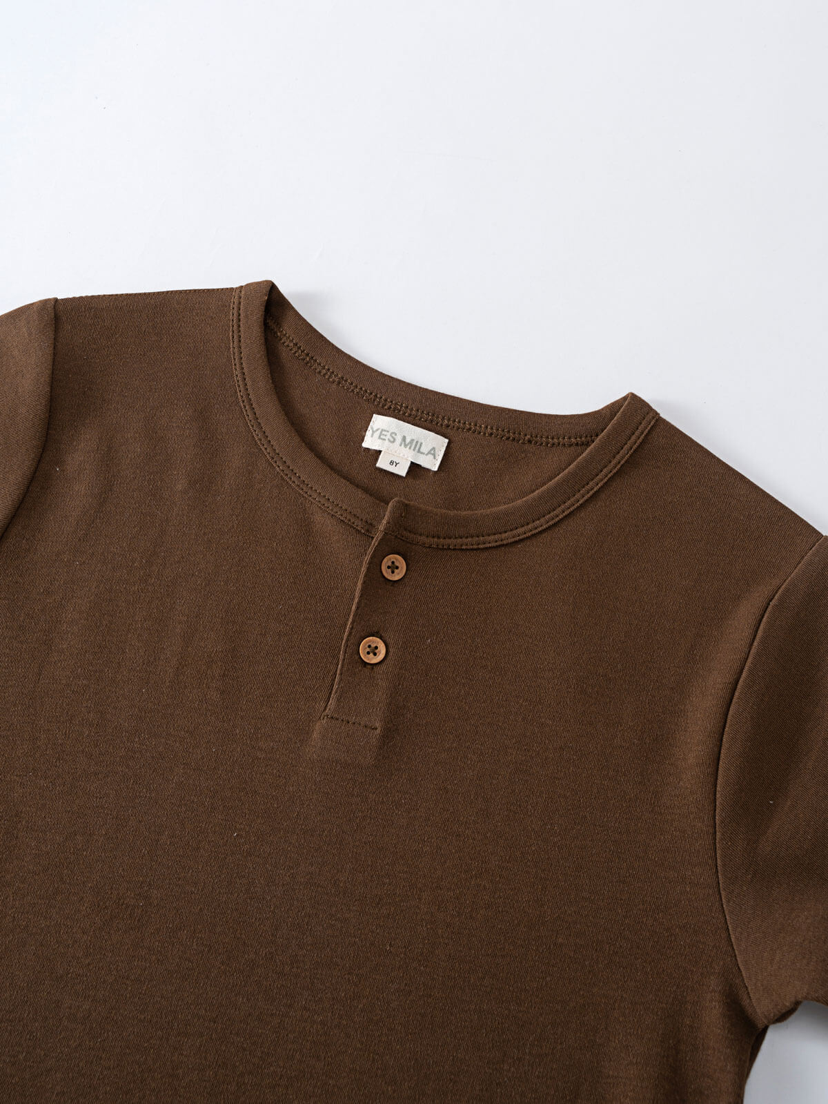 Close-up of a brown henley shirt with two buttons Henley Short Sleeve Tee - Spruce Boys