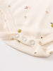 Close-up of cream-colored baby bodysuit with snap buttons and fruit embroidery Henley Short Sleeve Bodysuit - Autumn Harvest Ecru Baby girl