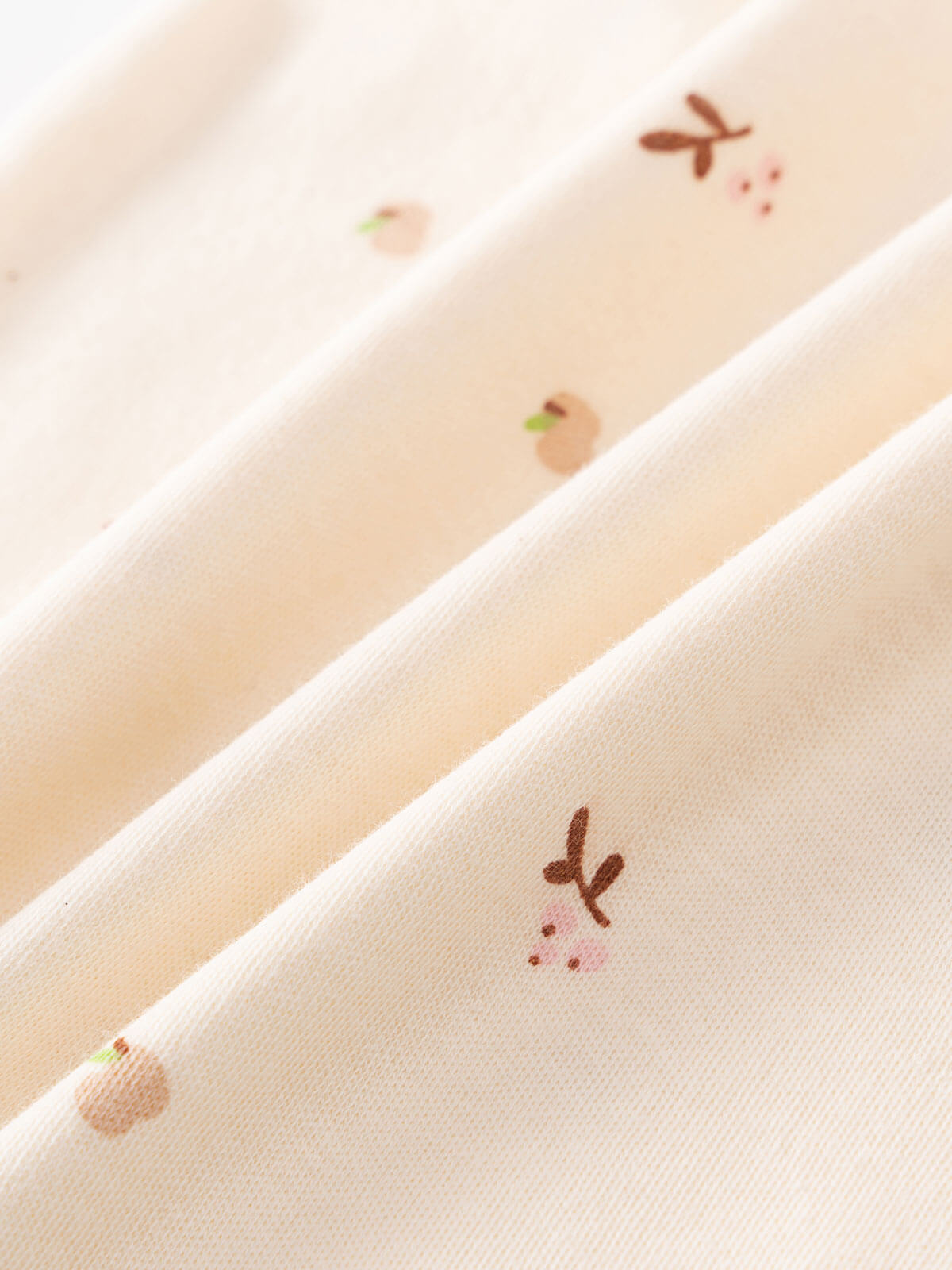Close-up of cream fabric with small embroidered autumn leaf and acorn details Henley Short Sleeve Bodysuit - Autumn Harvest Ecru Baby girl