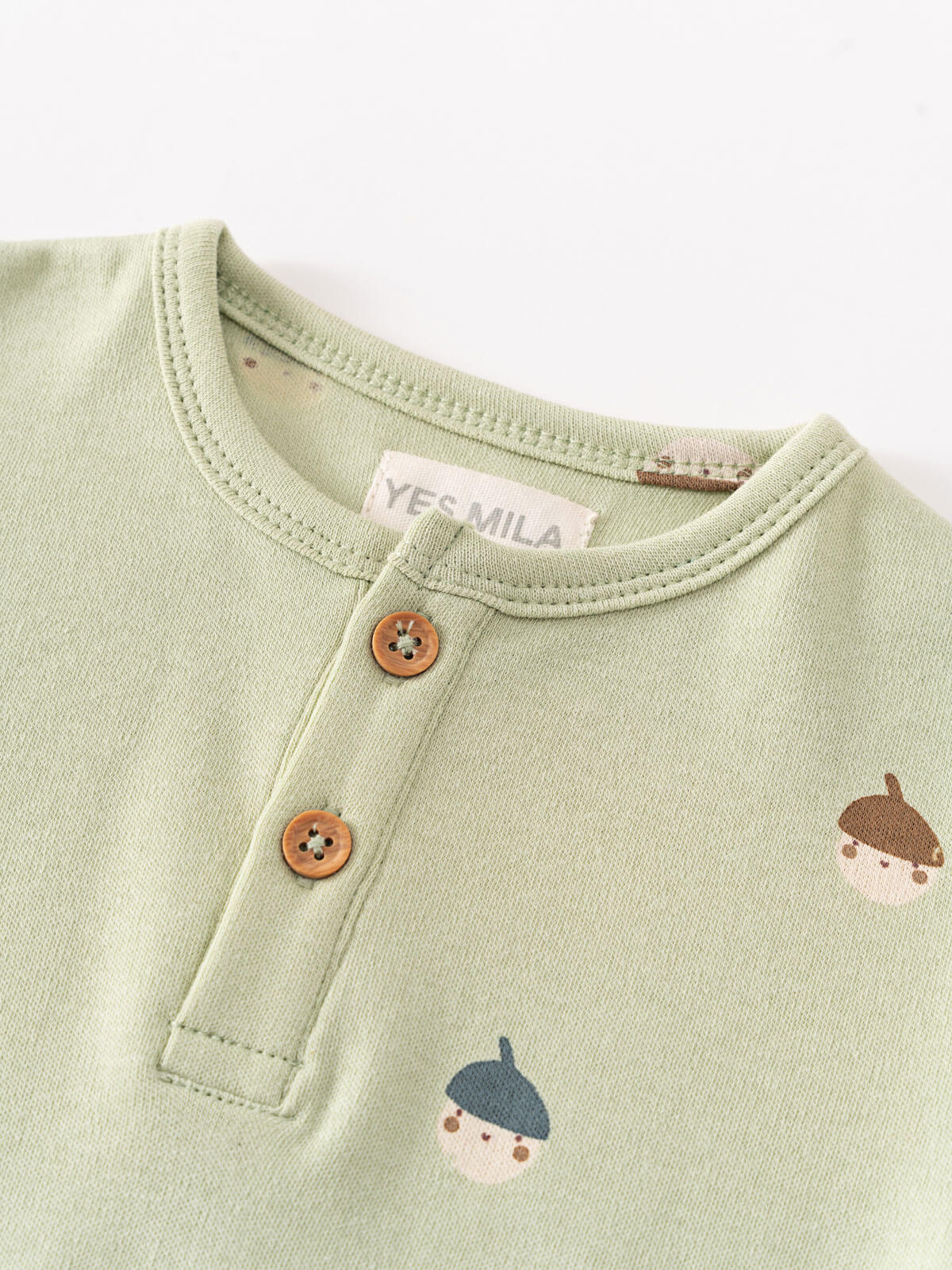 Close-up of sage green bodysuit with wooden buttons and acorn embroidery Henley Short Sleeve Bodysuit - Little Acorn Sage Baby boy
