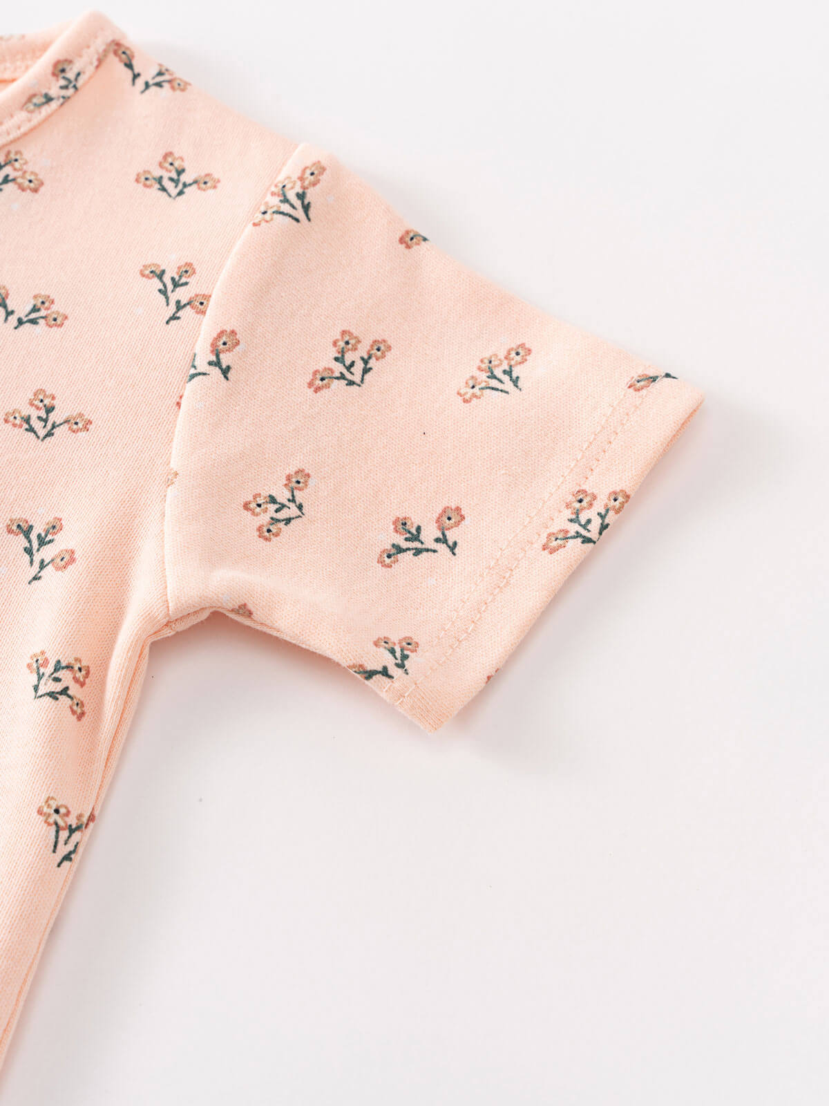 Pink baby shorts with small floral print pattern on white background Henley Short Sleeve Bodysuit - Wildflower Bouquet Pink Baby girl