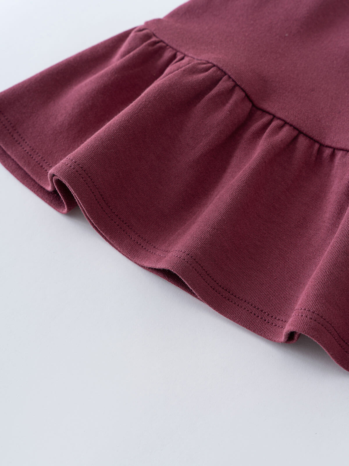 Close-up of a plum-colored jersey skirt waistband with gathered elastic detail Jersey Skirt - Plum Jam Girls