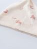 Close-up of cream fabric with small pink rabbit pattern print Knot Hat - Meadow Friends Ecru Baby girl