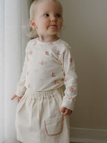 Toddler in a patterned long sleeve top and corduroy skirt standing indoors Long Sleeve Bodysuit - Meadow Friends Ecru Baby girl