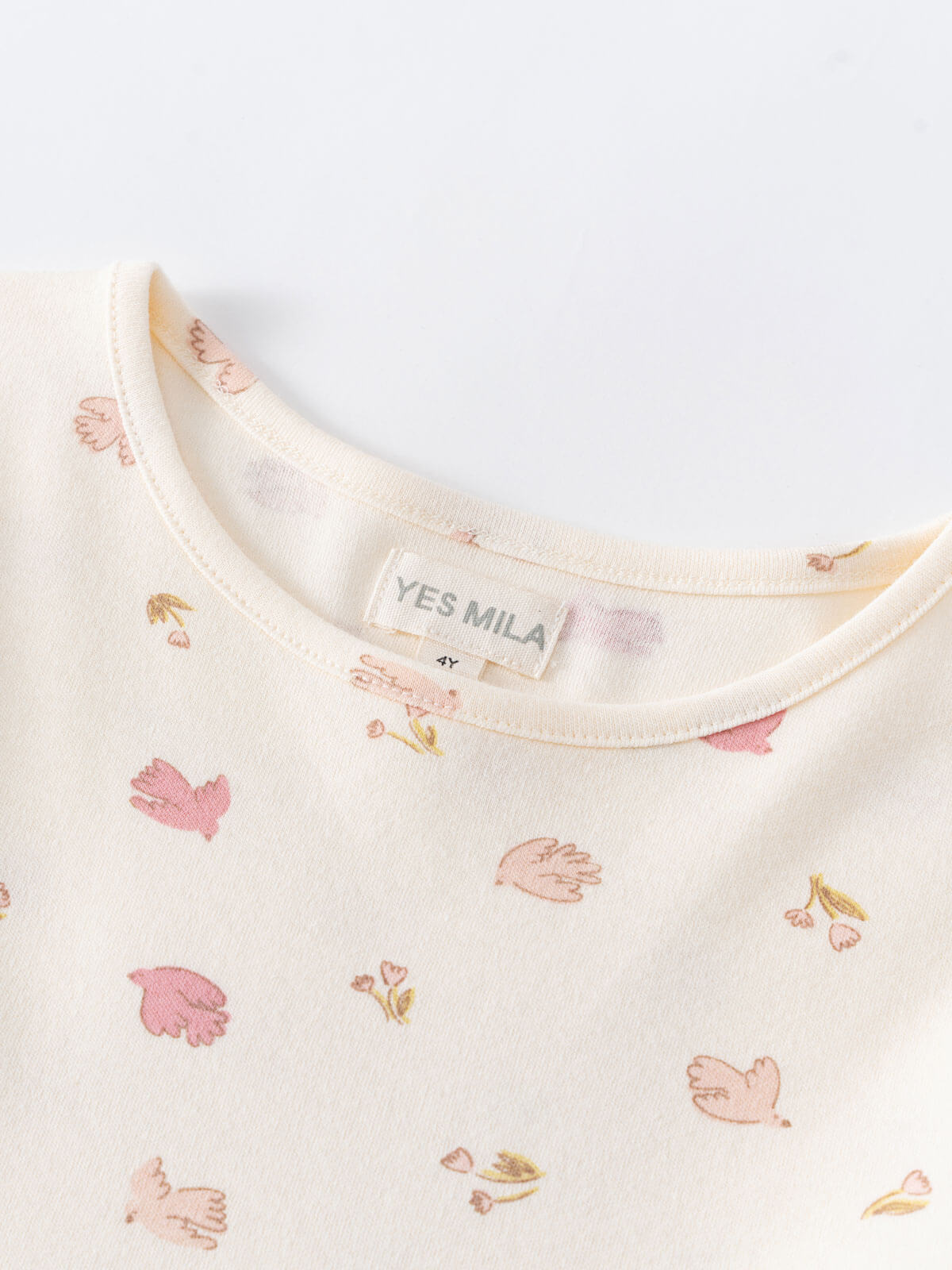 Close-up of cream jersey fabric with pink bird and blossom print Long Sleeve Jersey Dress - Bird And Blossom Ecru Girls
