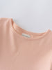 Close-up of a peach-colored jersey garment neckline with a white label Long Sleeve Jersey Dress - Mallow Girls