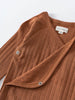 Close-up of a rust-colored ribbed bodysuit with snap closures Pointelle Crossover Bodysuit - Russet Baby boy