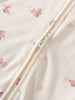 Close-up of cream fabric with pink animal print and beige zipper detail Printed Long Sleeve One Piece - Meadow Friends Ecru Baby girl